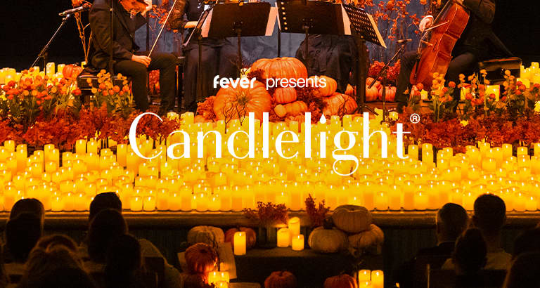 String quartet playing surrounded by candles and pumpkins at a Candlelight Halloween concert