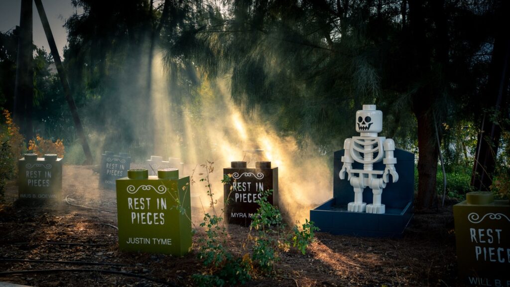 LEGO skeleton and Rest In Pieces gravestones in a misty Halloween graveyard at LEGOLAND Dubai
