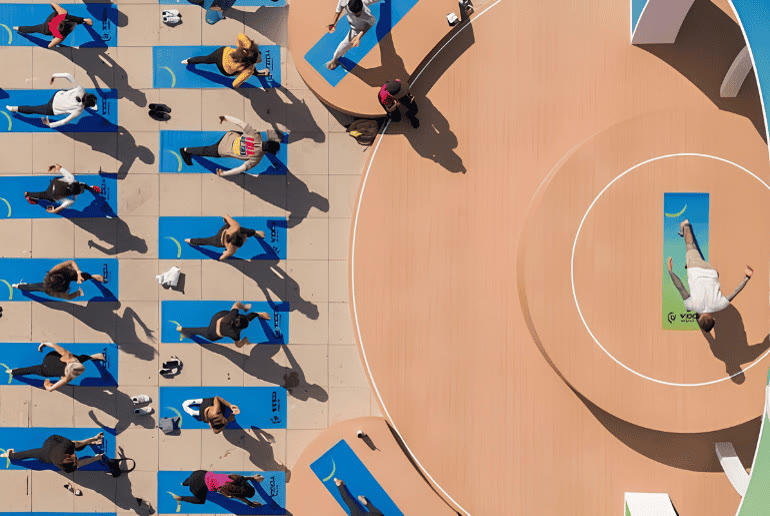 Aerial view of a free group yoga class on blue mats during the Dubai Fitness Challenge 2026