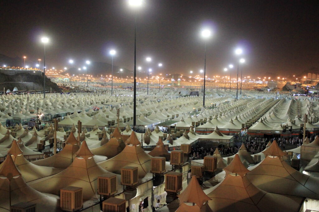 The tent city of Mina lit up at night during Hajj