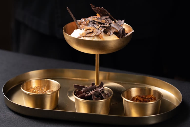 Chocolate dessert on a gold stand at ANA Restaurant in The Dubai Mall