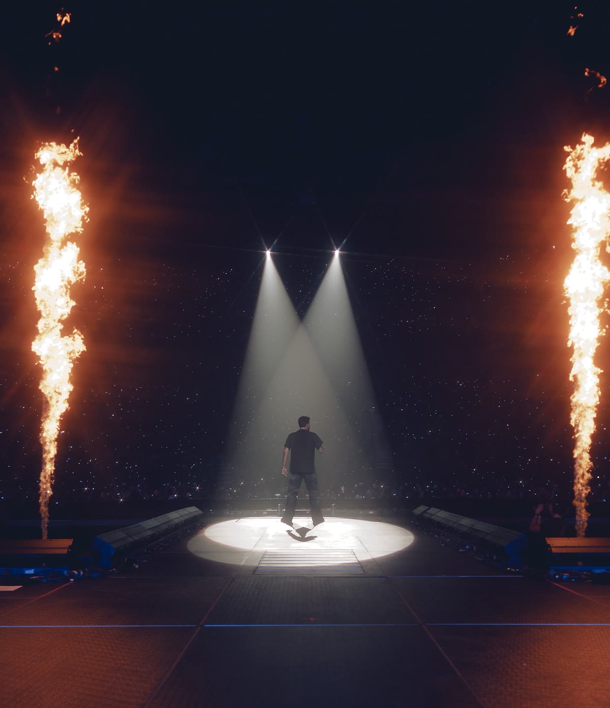 A festival stage with flames and spotlights, promo image for UNIFYD Festival Abu Dhabi