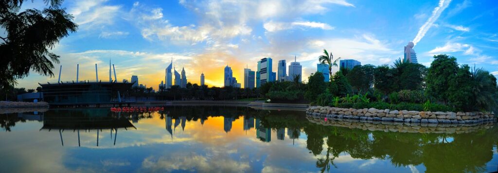Dubai skyline reflected in the lake at Zabeel Park at sunset